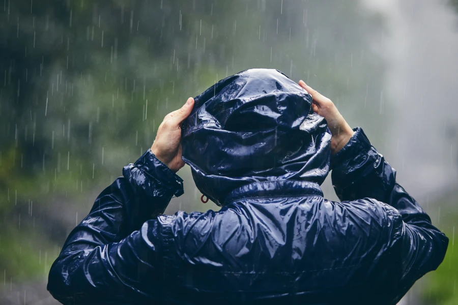 muž v kapuci v daždi