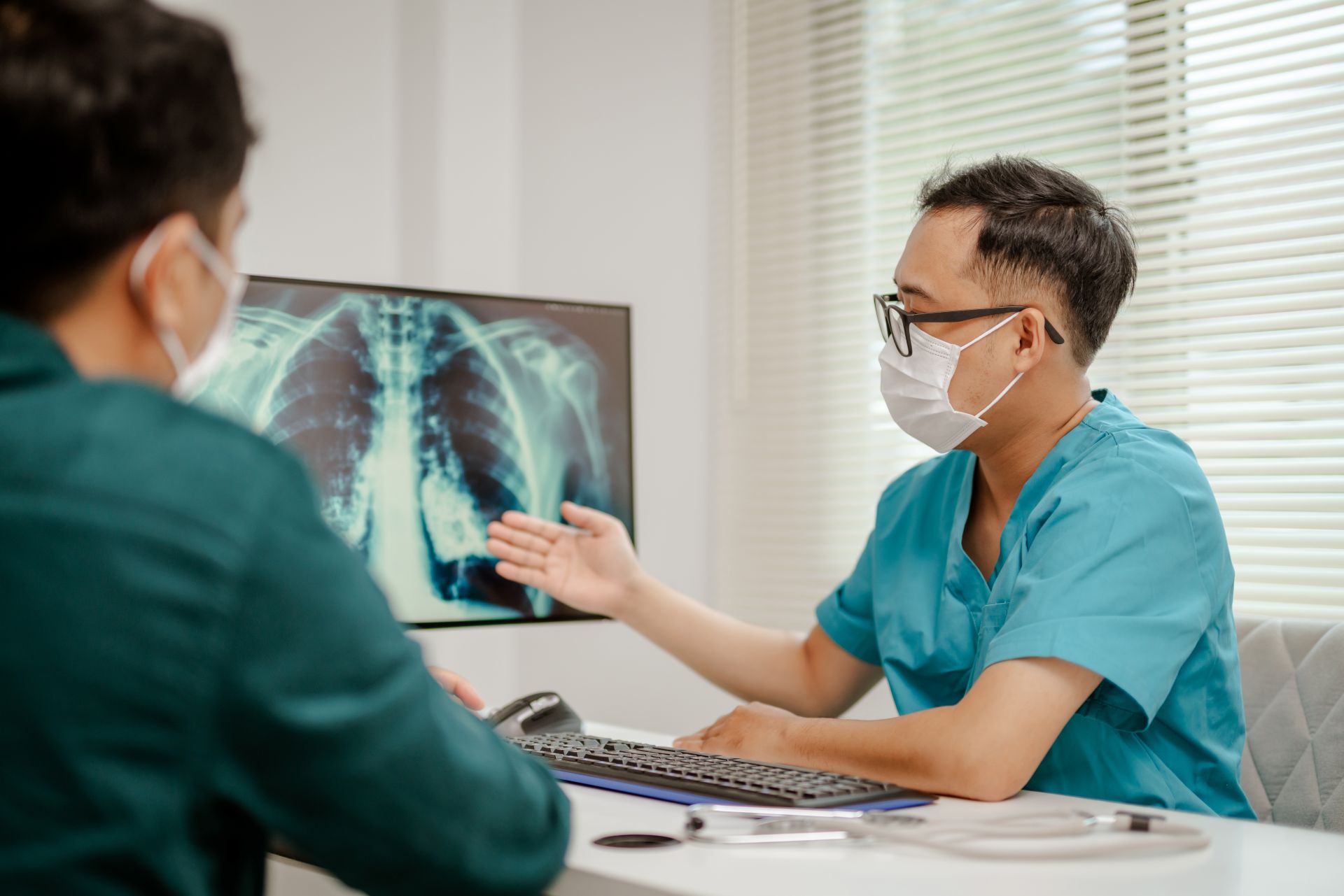 lekár s pacientom sedia v ordinácii a prezerajú si RTG hrudníka