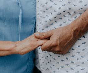 muž a žena si držia navzájom ruku